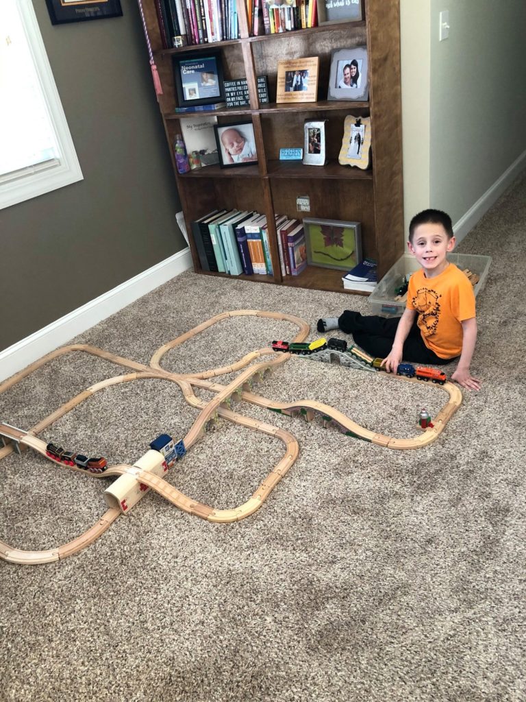 William playing with his favorite wooden train set that fits Thomas, Brio, Chuggington, Melissa and Doug, and Imanginarium sets